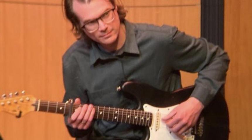 jason mullen playing the acoustic guitar on stage